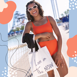 girl wearing a bathing suit standing in front of ocean